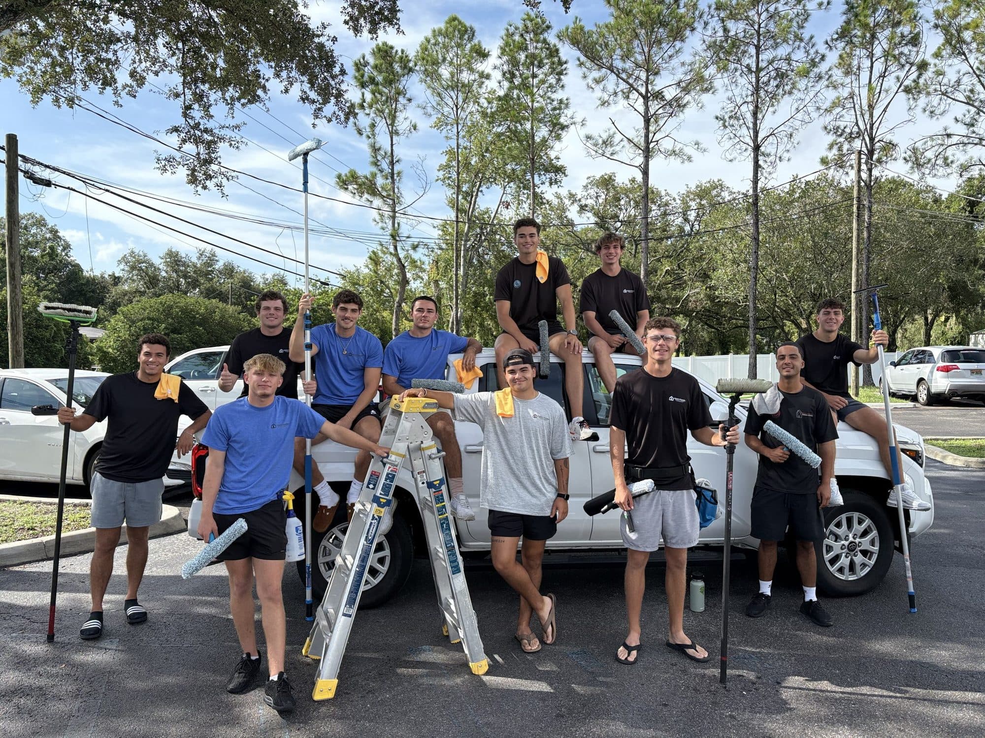 The full Fresh Frames crew with their window-cleaning equipment