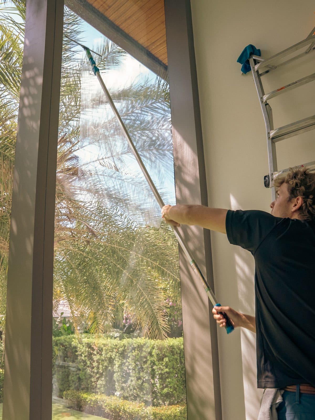 Squeegeeing a sliding glass door to a streak-free, crystal-clear finish